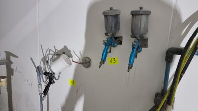 two airbrushes on the wall in a room