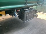 a green truck with a black box on the back