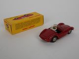 a red toy car sitting next to a yellow box