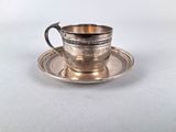 silver plated cup and saucer on a white background