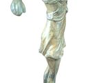 bronze statue of a woman throwing a ball on a pedestal