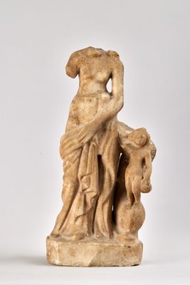 statue of a woman holding a child on a white surface