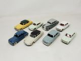 several toy cars are lined up in a row on a white surface