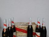 four bottles of wine sitting on a table next to a box of wine