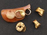 une image représentant une brosse à dents et quelques clochettes dorées sur un fond noir