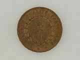 an old gold coin on a white surface with a white background