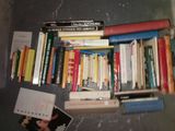 a lot of books that are on the floor