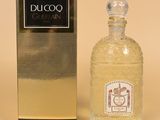 perfume bottle in front of a box and box on a beige background