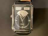 a watch that is sitting on a black table