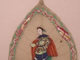 three decorative plates with a woman on them hanging on a wall