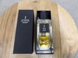 an image of a bottle of perfume sitting on top of a wooden table