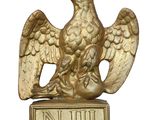 gold eagle with crown on top of a metal sign post