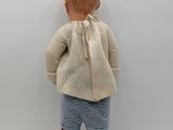 an image of a doll of a boy in a sweater and shorts