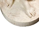 a statue of a woman with her feet on a table