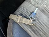 an image of a car seat belt with a car key attached to it