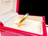 a red box with a gold ring inside of it