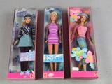 three barbie dolls are in a box on a table