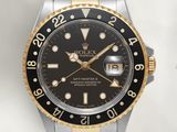 Montre Rolex à cadran noir et lunette en or jaune