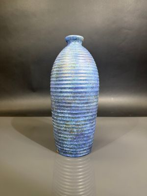 a blue vase that is sitting on a table