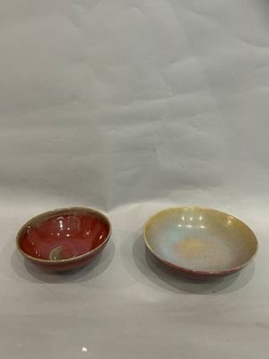 two bowls sitting on a table with a white background
