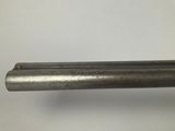 a close up of a metal pipe on a white surface