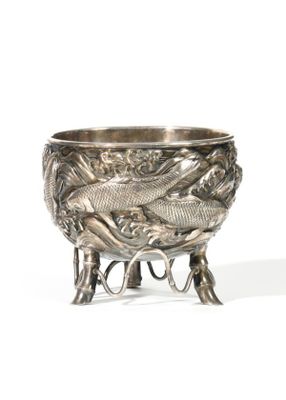 a silver bowl with two fish on it