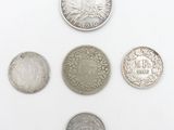 six different types of coins are shown on a white surface
