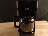 a coffee maker that is sitting on a wooden table