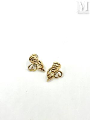 a pair of gold earrings with diamonds on them