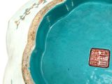 a blue bowl that has a small square in it