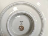 a white plate with a gold design on it