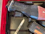 a red tool box with tools in it on the floor