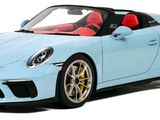 the blue porsche 911 speedster is parked on a white surface