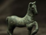 a small statue of a horse that is standing on its hind legs