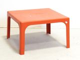 a small orange table with a small white dot on it
