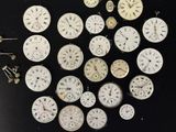 many different types of clocks on a black surface