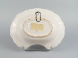 underside view of a white porcelain bowl with a tag on it