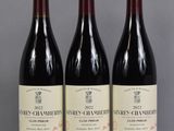three bottles of wine are lined up on a table