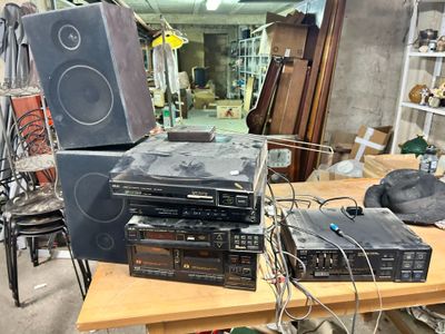 a lot of electronics sitting on a table in a room