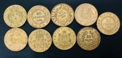 a group of six gold coins sitting on top of a black surface