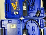 three blue plastic boxes with wires and wires attached to them