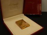 an image of a gold plated cigarette case in a red box