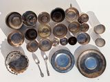 a lot of silver and blue dishes and spoons on the table
