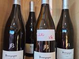 several bottles of wine are lined up in a wooden box