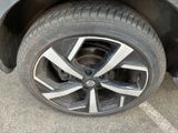 a close up of a tire on a car in a parking lot