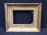 an old picture frame with a black background and gold trim
