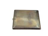 an antique silver cigarette case with a metal cover on a white background