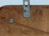 a piece of wood with a metal latch on it