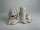 a statue of a lion that is sitting next to a pillar