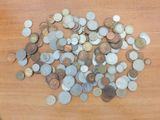 a pile of coins sitting on a wooden table